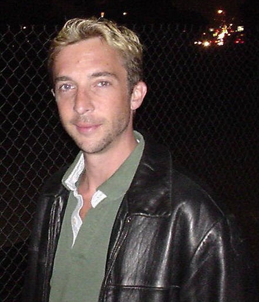 Sean with blonde hair tips and a leather jacket