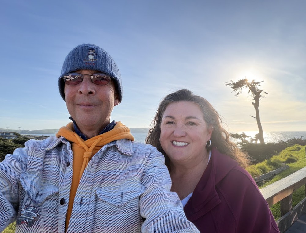 Sean and his wife outdoors on the Northern California coast